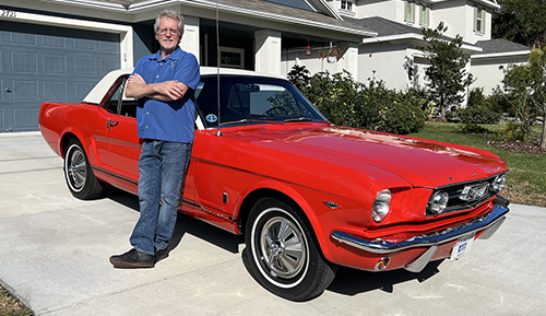 Front cover of Art of the Mustang book with shiny black Ford Mustang top view